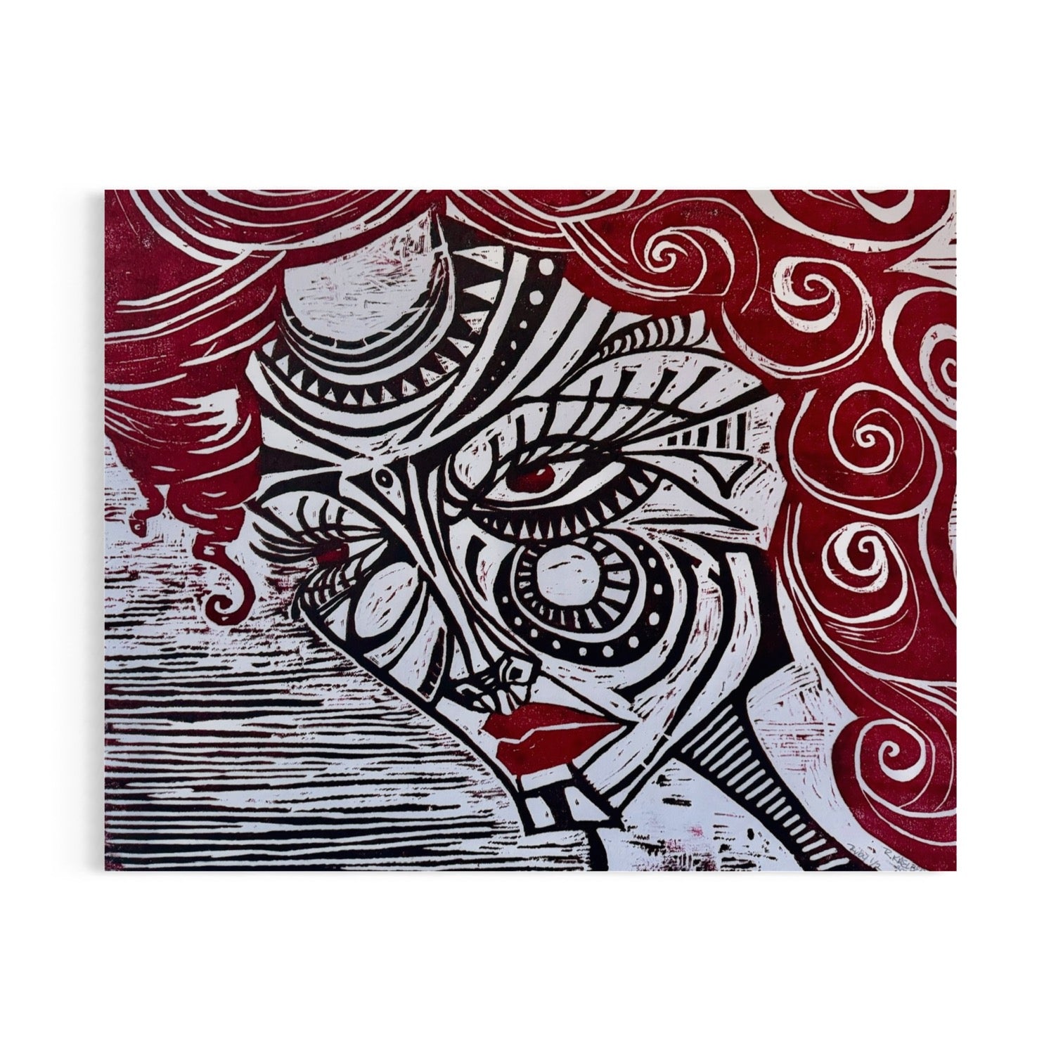 Ruby the Revolutionary. Three quarter view face. Stylized woman’s face with black designs and red curly hair. Woodblock print on white paper.