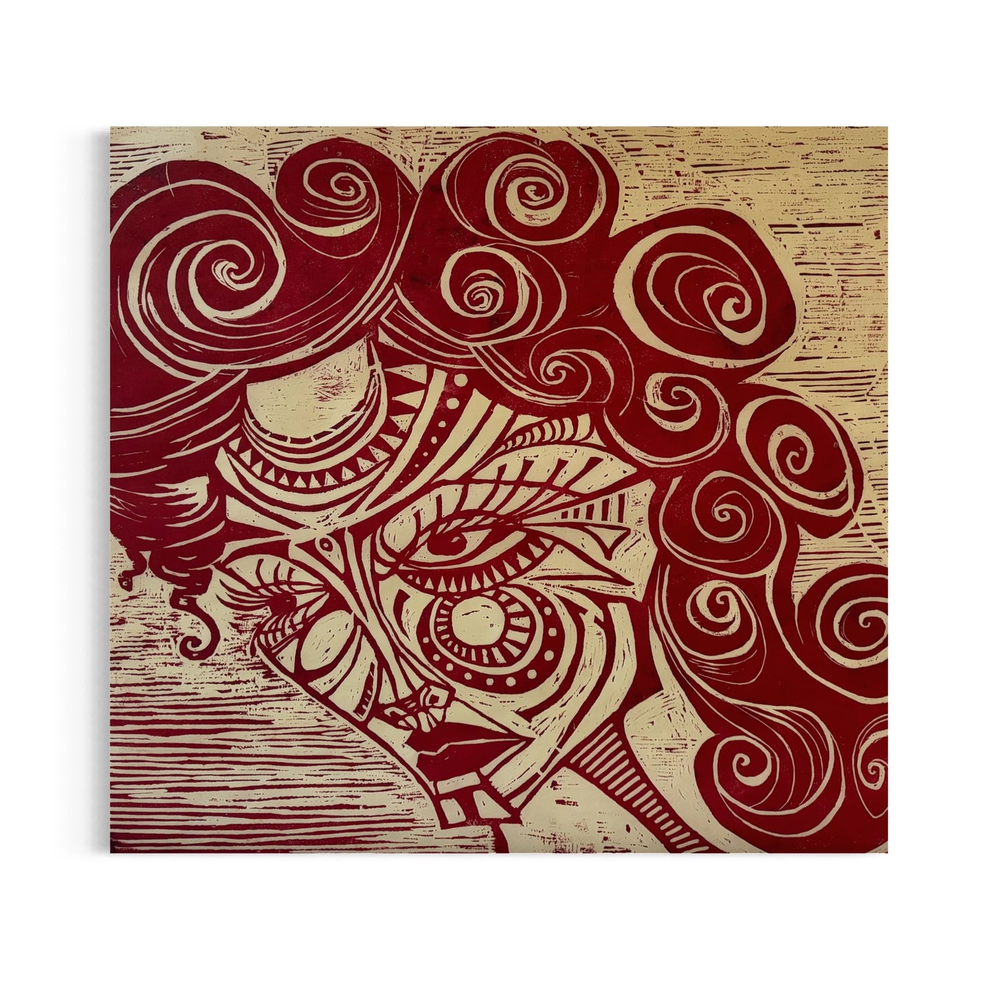 Red woman’s face and hair with designs in facial features. Woodblock print with red ink on mulberry paper.